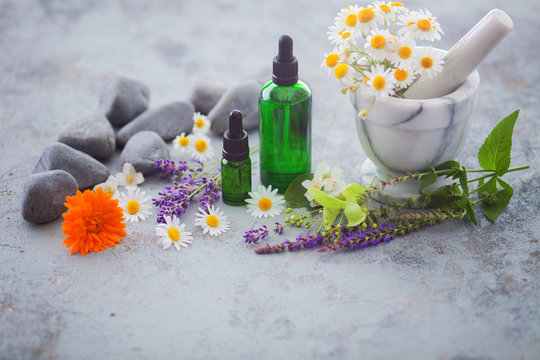 aromatherapy oil with fresh herbs and flowers