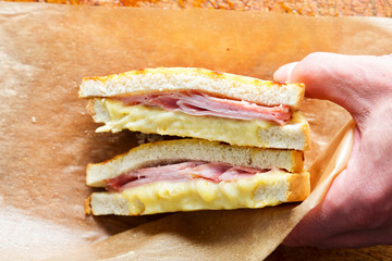 Ham cheddar cheese toastie. Bread with ham, cheese & mustard sauce & grilled cheddar and b&eacute;chamel sauce topping
