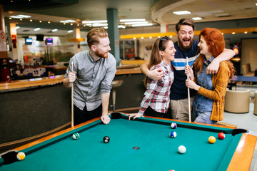 Group of people playing snooker