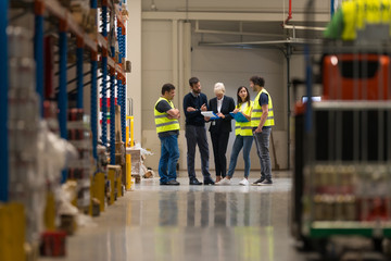 Workers with supervisors at warehouse