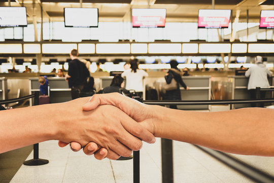 Man shaking hands in airport terminal