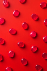 top view of collection of candies on red surface