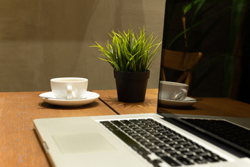 Business still life selected coffee cup with laptop on wooden table