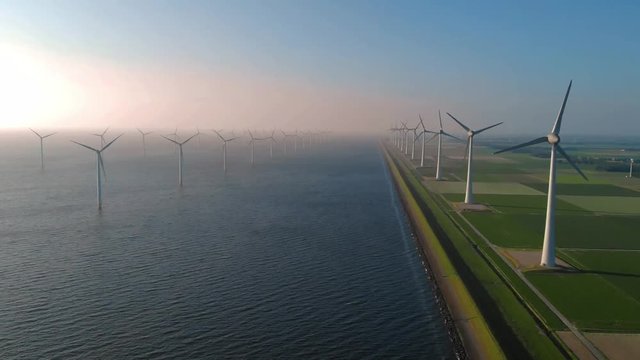 Offshore Windmill farm in the ocean  Westermeerwind park , windmills isolated at sea on a beautiful bright day Netherlands Flevoland 