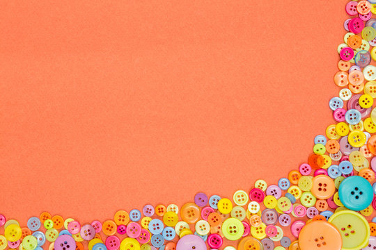 Colourful buttons on an orange background with copy space.