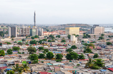 High angle view over slums of Luanda with Mausoleum of Agostinho Neto tower in background, Angola, Africa