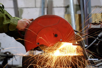 worker cutting metal