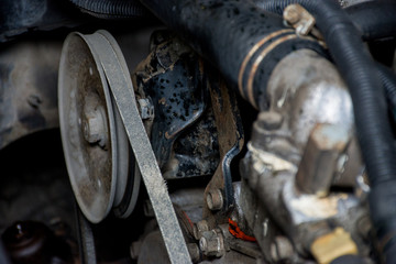 Details of a dirty diesel engine under the hood of car