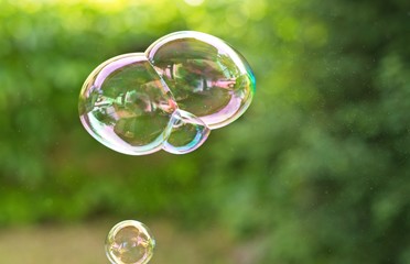 Flying soap bubbles close up. Outdoors