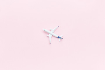 Travel concept. Airplane on a pink background. Place for text.