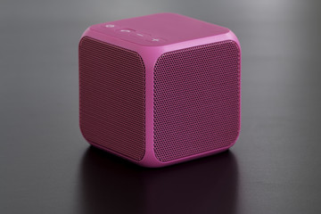 Pink bluetooth speaker cube close-up