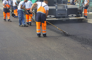 Construction workers on asphalting and road repair