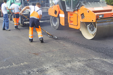 Construction workers on asphalting and road repair