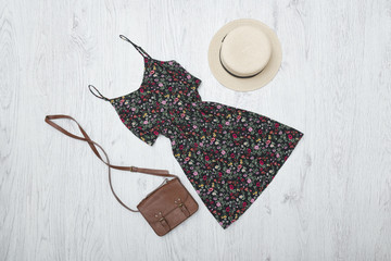 Black summer dress, handbag and hat. Fashionable concept