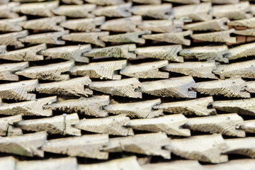 Side of view on old roof with wooden shingles. Texture. Close-up