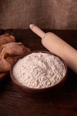 Cottage cheese cookies and little flour on oak wooden background. Macro, close up. Selective focus