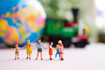 Miniature people, children playing outdoor using as family and education concept