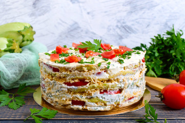 A delicious cake of zucchini, tomatoes and cheese on a wooden table. Vegetable cake.