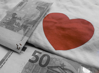 red heart and black and white euro banknotes on a white background