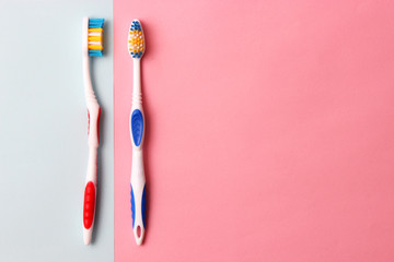 toothbrushes on a colored background top view. oral health, brush your teeth, healthy teeth