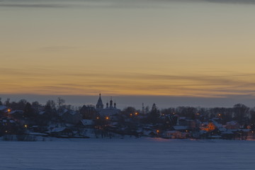 Fototapeta na wymiar Night winter landscape of the old Russian city on the Volga River