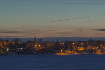 Night winter landscape of the old Russian city on the Volga River