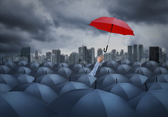 businessman with red umbrella among others, unique different concept