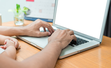 Close up hands father and little son typing someting on laptop computer on workplace at office home happiness laughing together, happy family concept.