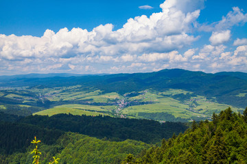 View from the top of the mountain to the Sromowce village by the river. Bialy Dunajec in Pieniny, view from the top of the Three Crowns. The highest peak of the Pieniny, Trzy Korony.