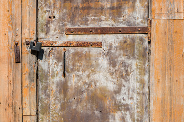 Old wooden door with rustic paclock