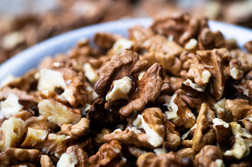 Walnuts kernels with color background, Whole walnut in a metal plate. Walnuts. Walnuts an market. Background of walnuts. Healthy. Fresh