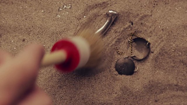 Statue of lady Justice with scale buried in sand, concept of unsolved cold case crime