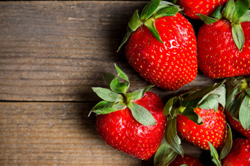 Ripe strawberries on the rustic background. Selective focus.