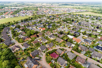 Aerial view of a suburb with detached houses, semi-detached houses and terraced houses with small...