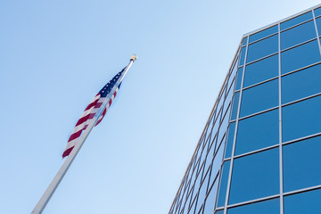 Glass Windowed Building Parallel to American Flag