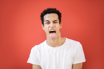 Young man sticking his tongue out