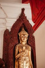 Fototapeta na wymiar Old golden Buddha sculpture at Wat Phra Mahathat Nakhon Si Thammarat, Thailand