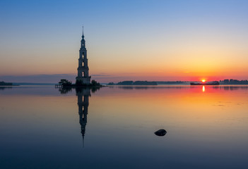 Fototapeta na wymiar Flooded bell tower of St. Nicholas Cathedral in Kalyazin Kalyazin at sunrise, Tver region, Russia