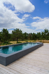 Modern house with garden swimming pool and wooden deck