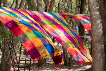  Beautiful Mexican multicolored blankets fluttering in the wind at the souvenir stand