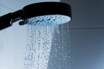 Naklejka na ściany i meble Showerhead and pouring water.