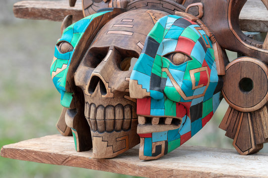 Stand with handmade, colorful Mexican souvenirs - figurines, traditional sculptures, Mayan calendars, masks
