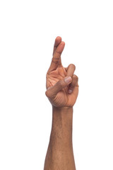 Black hand crossed fingers fo luck isolated on white