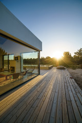 Modern house with garden swimming pool and wooden deck