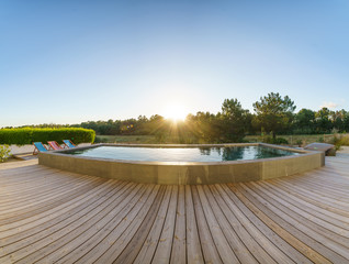 Modern house with garden swimming pool and wooden deck