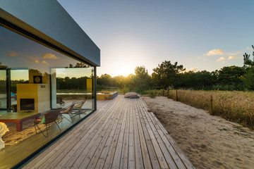 Modern house with garden swimming pool and wooden deck