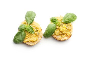 Toasted bread with basil and sauce on white background