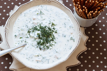 Cold soup with yogurt. Cold soup with cucumber and herbs with yoghurt filling. Top view.
