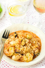 Italian rice dish risotto with seafood, shrimps and mussels