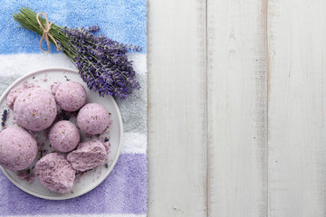 Fototapeta na wymiar Handmade lavender bath bombs and flowers on white table